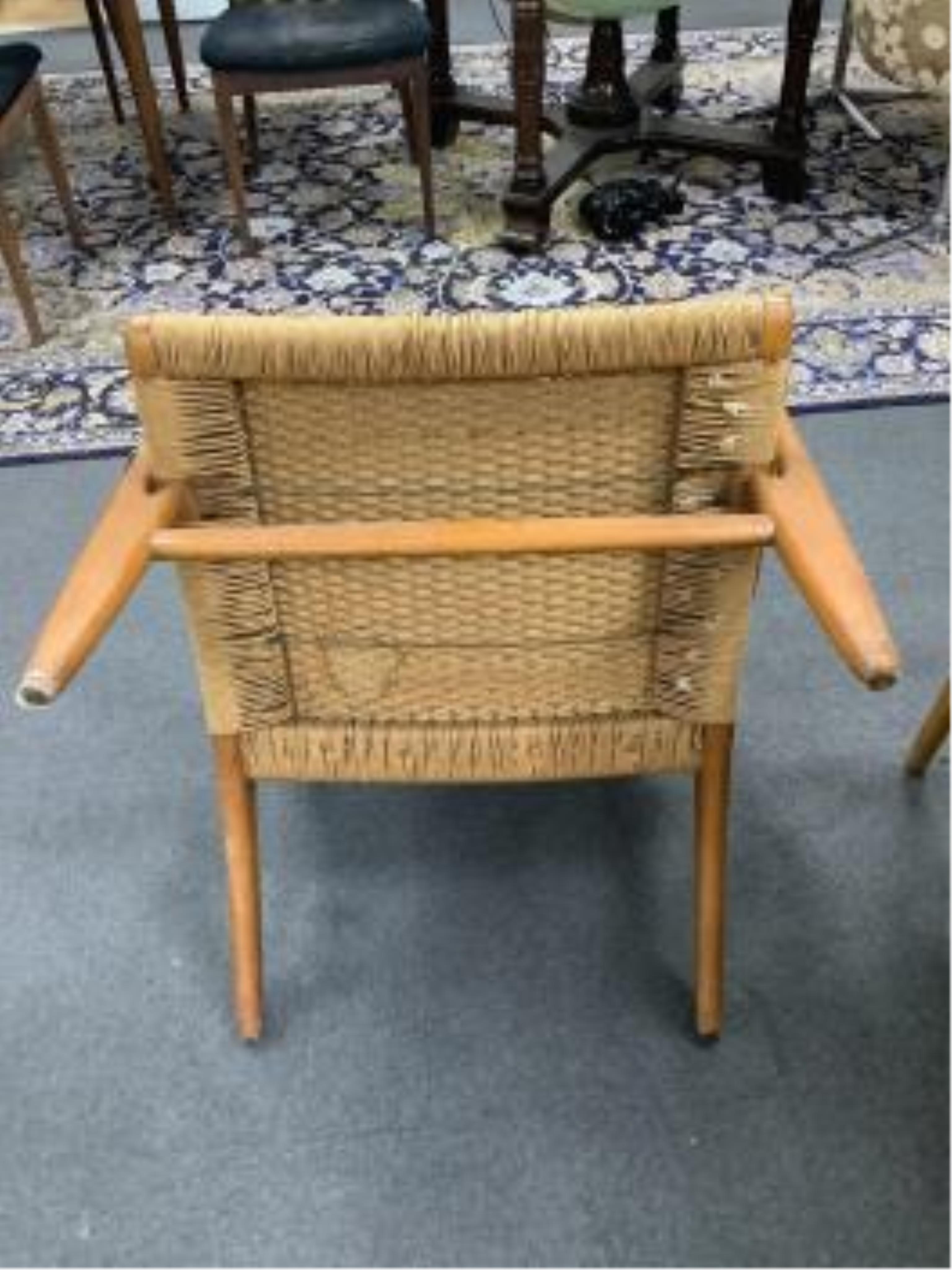 Hans J Wegner for Carl Hansen & Son, a model CH25 oak beech and paper cord lounge chair, width 70cm, depth 70cm, height 74cm. Condition - fair